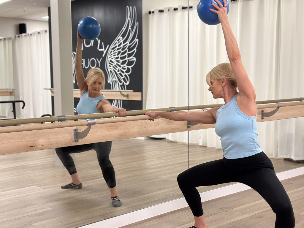 Woman performing a barre workout in a Fort Myers studio